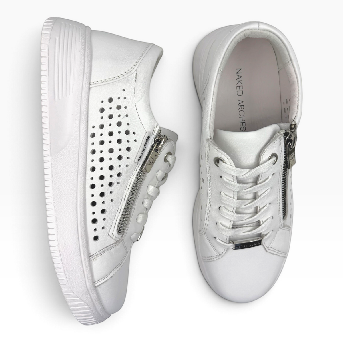 The Shoe Shop Noble white leather sneakers with side zip, lace-up fastening, and perforated punch-hole detailing.