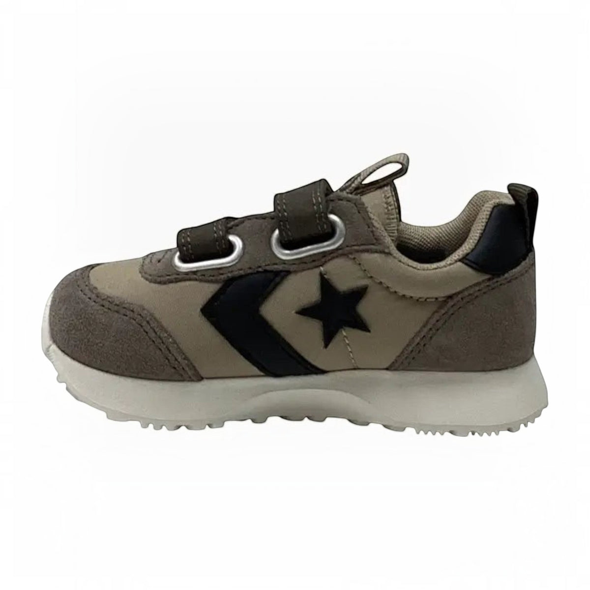 The Shoe Shop Omega Trainer infant sneaker in taupe suede with black star logo and dual hook-and-loop straps.