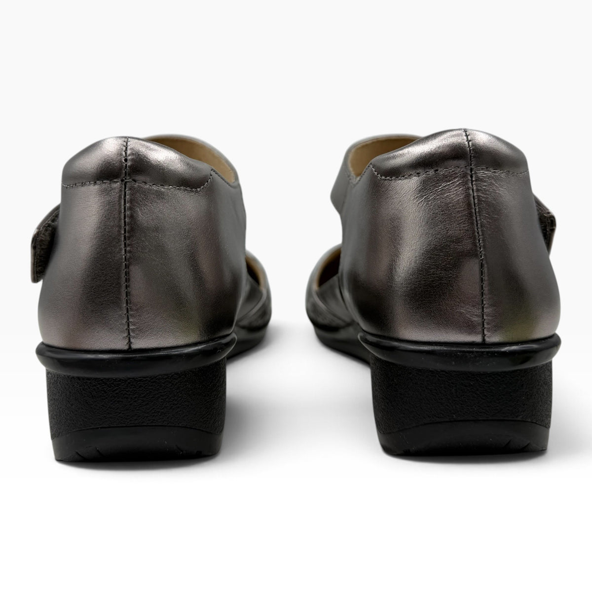 The Shoe Shop Osaka metallic silver leather shoes with a low black heel, shown from a rear view.