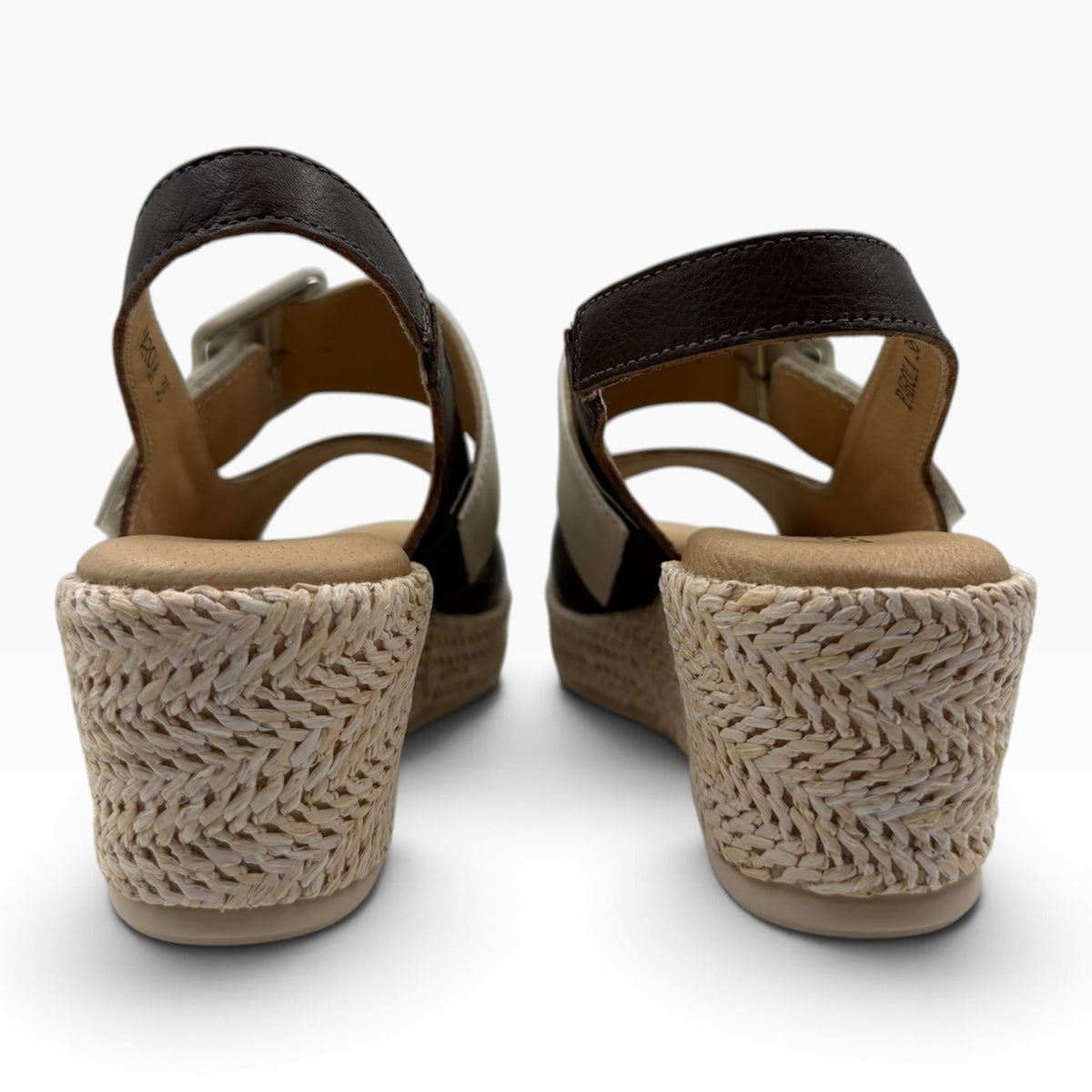 The Shoe Shop Parola two-tone leather wedge sandals with raffia-covered heels and adjustable straps, back view.