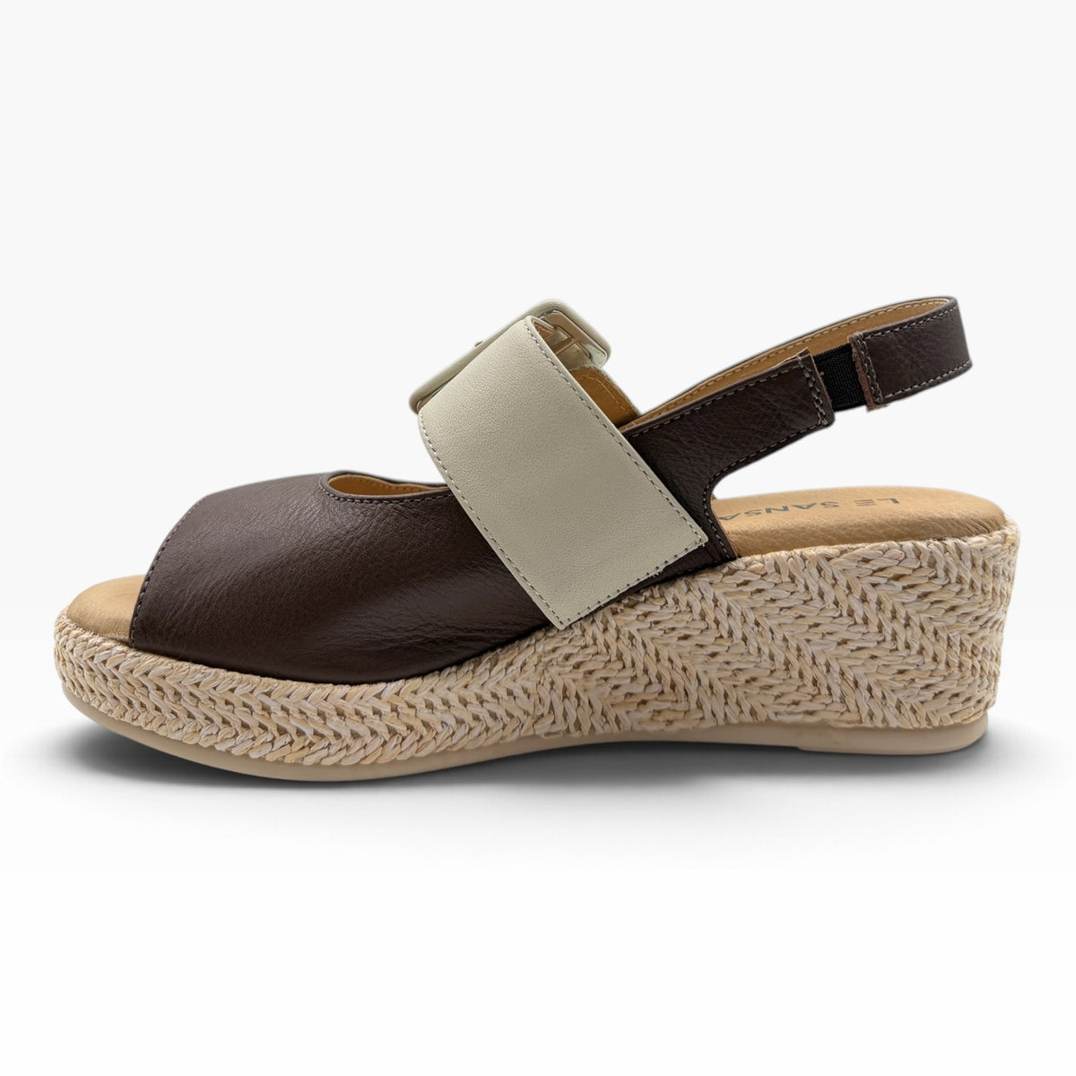 The Shoe Shop Parola two-tone brown and cream leather wedge sandal with a raffia-covered sole and adjustable strap.