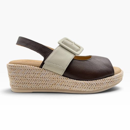 The Shoe Shop Parola two-tone leather wedge sandal with a raffia-covered sole and adjustable strap.