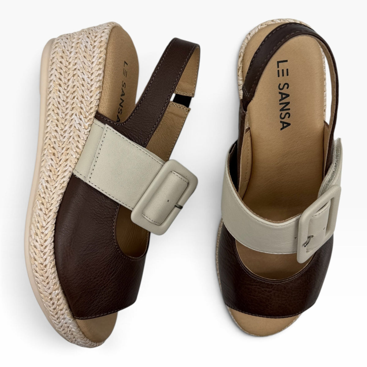 The Shoe Shop Parola two-tone leather wedge sandal with raffia-covered heel and adjustable strap.