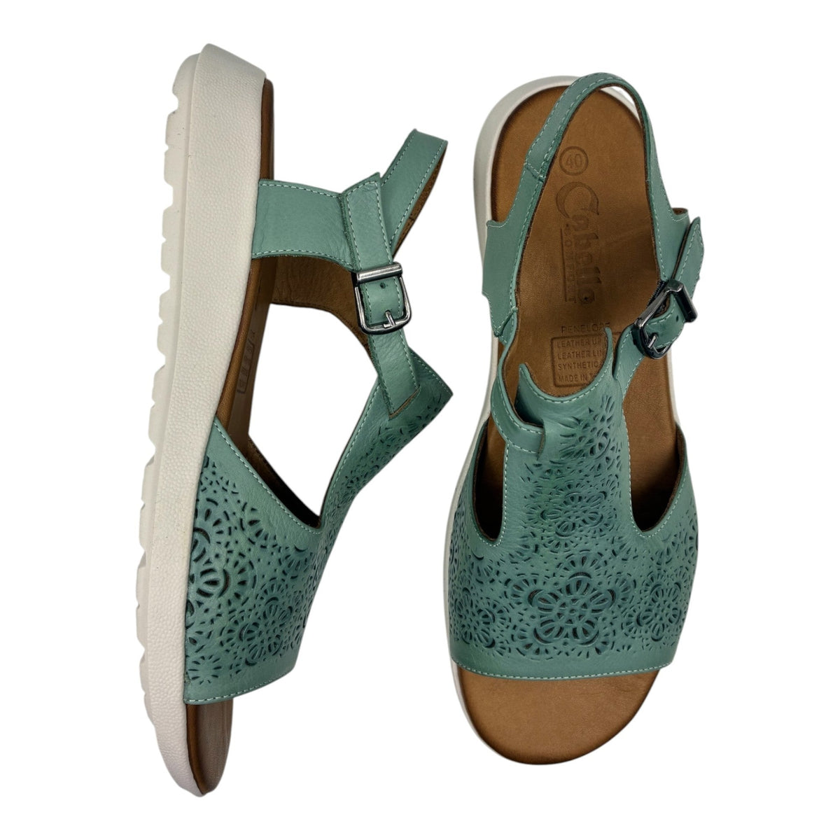The Shoe Shop Penelope mint green leather sandals with laser-cut floral patterns, adjustable strap, and wedge heel.