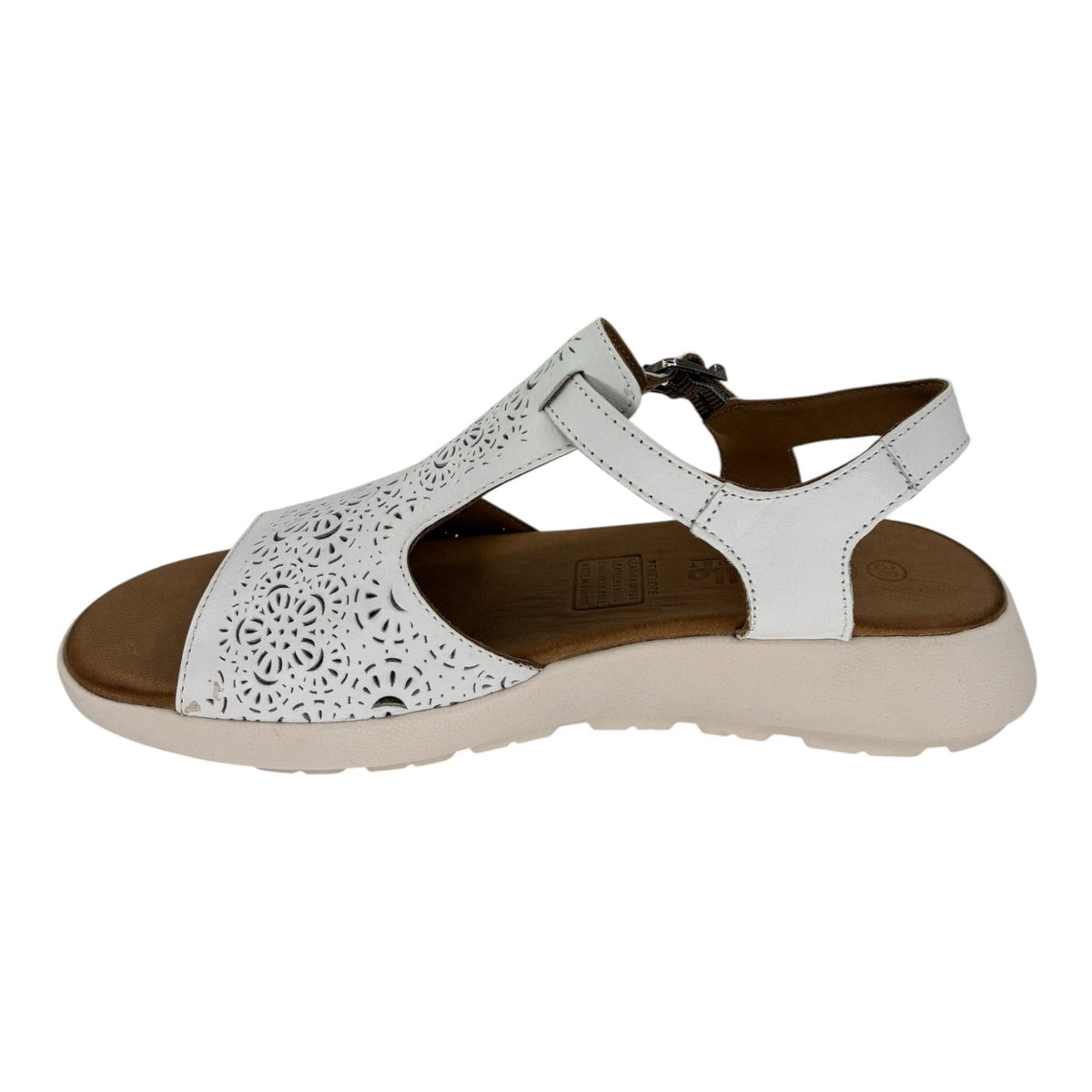 The Shoe Shop Penelope white leather sandal with laser-cut floral detailing, adjustable strap, and wedge heel.