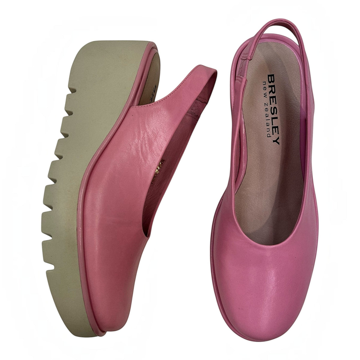 The Shoe Shop Party pink leather slingback wedge shoes with a thick beige rubber sole for comfort and stability.