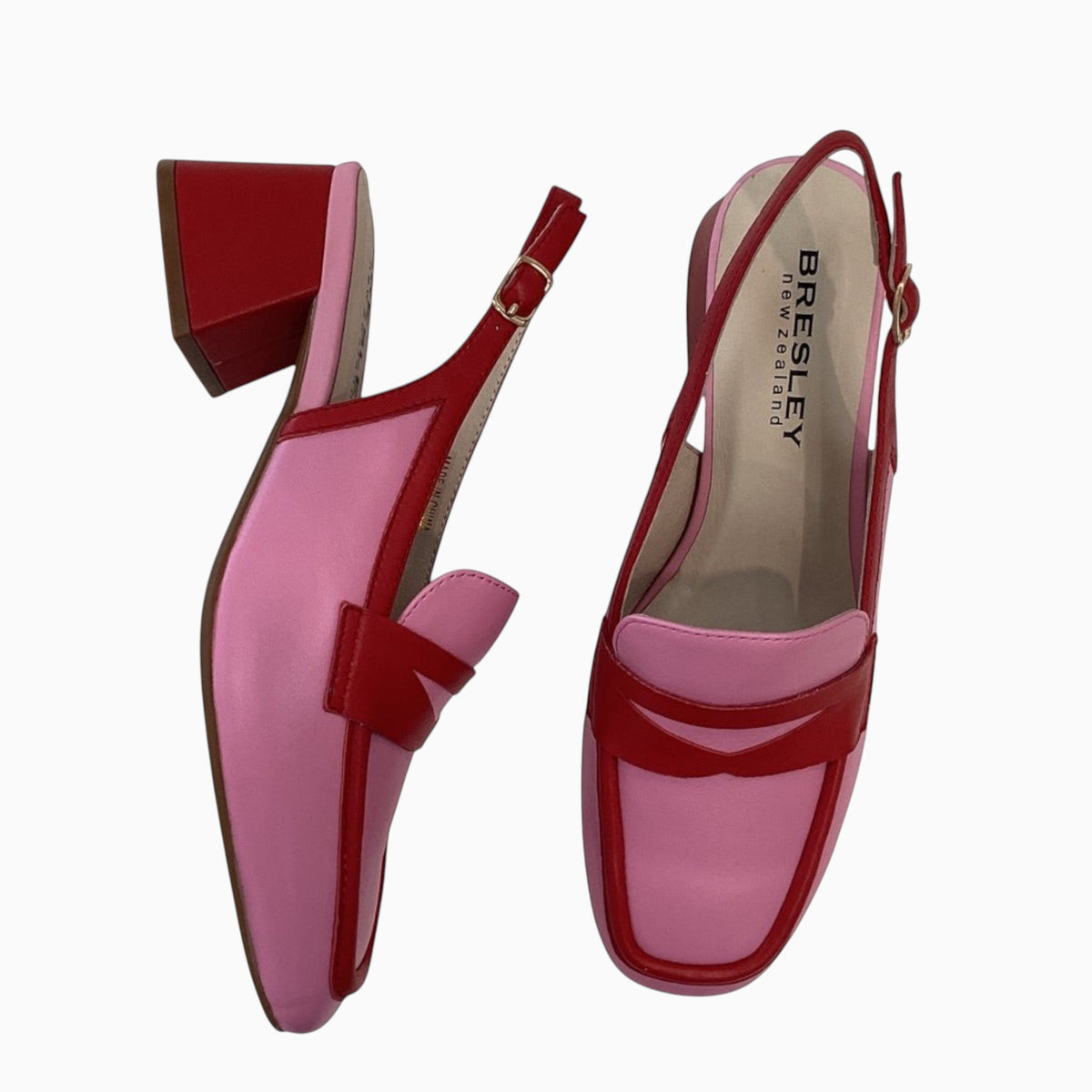 The Shoe Shop Peony slingback loafers in pink and red leather with a block heel and adjustable buckle strap.
