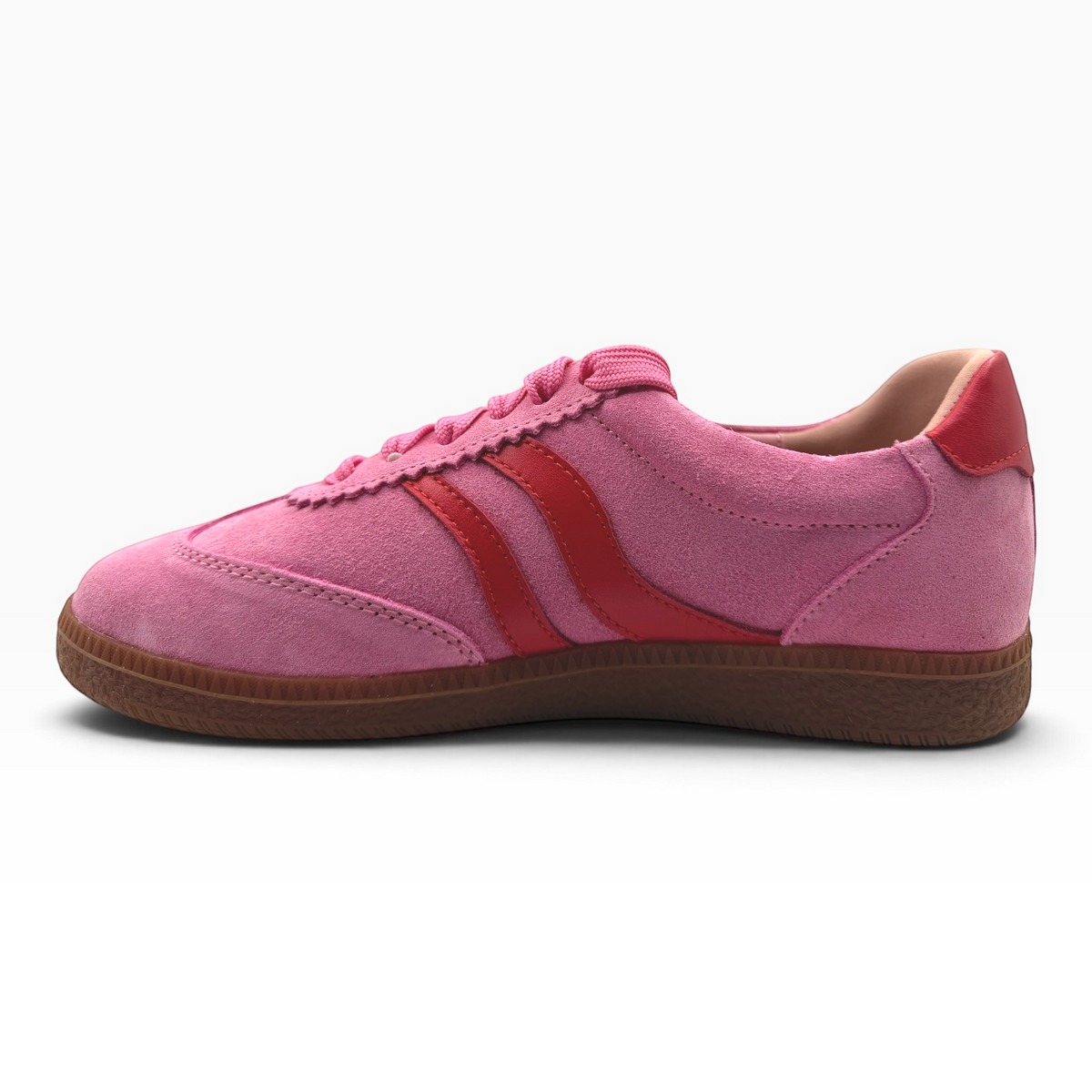 The Shoe Shop Hamptons pink suede sneaker with red leather stripes and a gum rubber sole, side profile view.