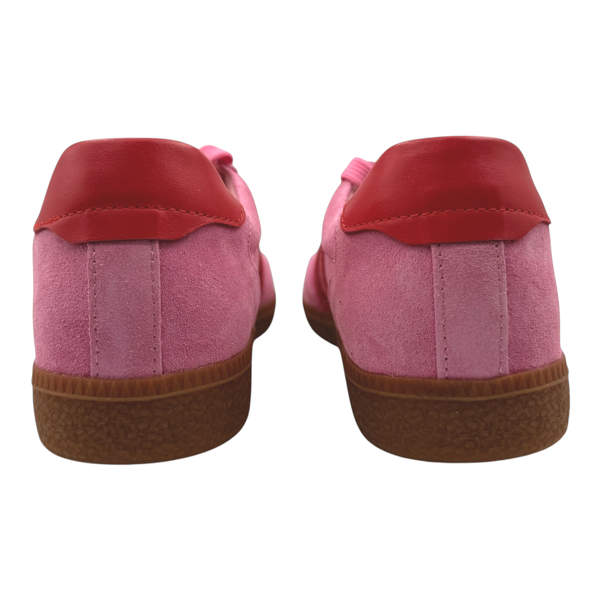 The Shoe Shop Hamptons pink suede sneakers with red leather heel tabs and textured brown gum soles, rear view.