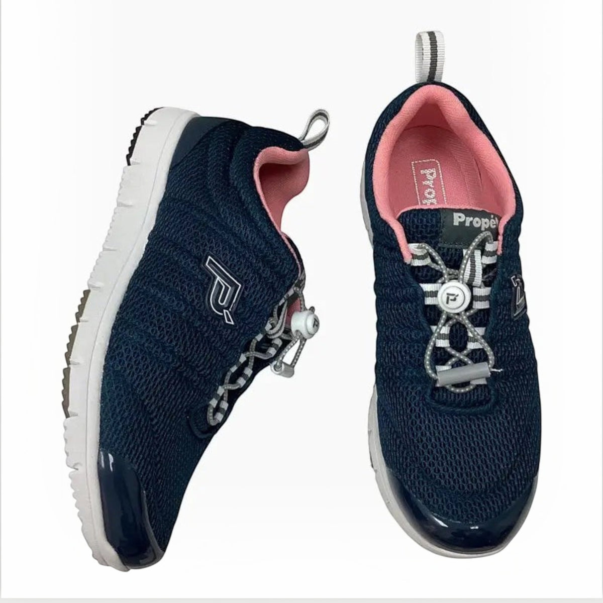 The Shoe Shop Propet Travel Walker II navy blue mesh walking shoe with pink lining and bungee toggle closure.