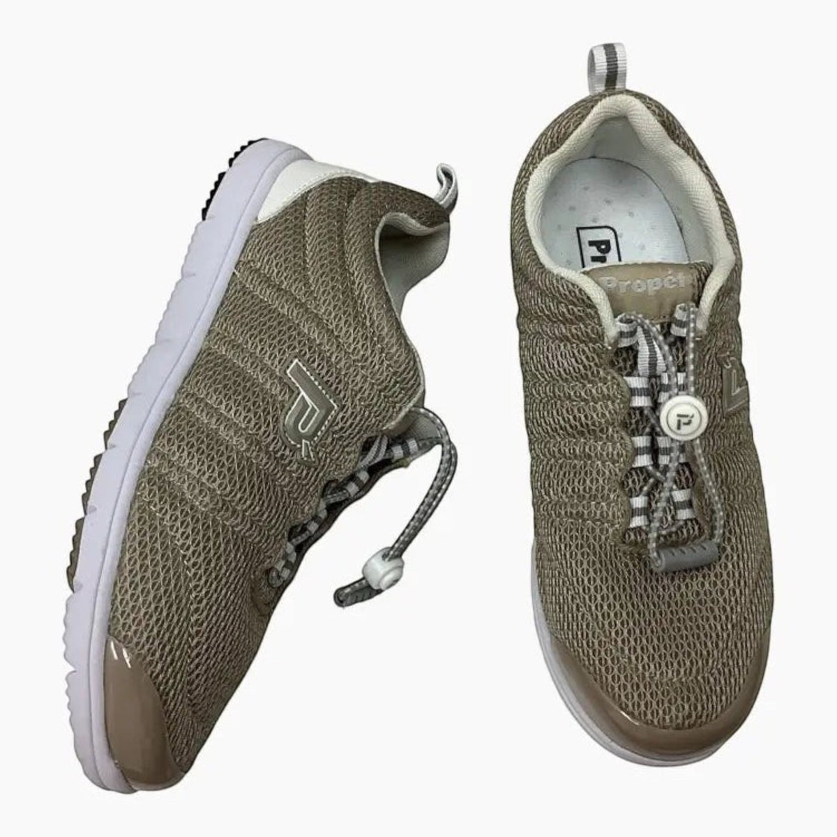 The Shoe Shop Propet Travel Walker II beige mesh walking shoes with bungee toggle closure and white rubber outsoles.