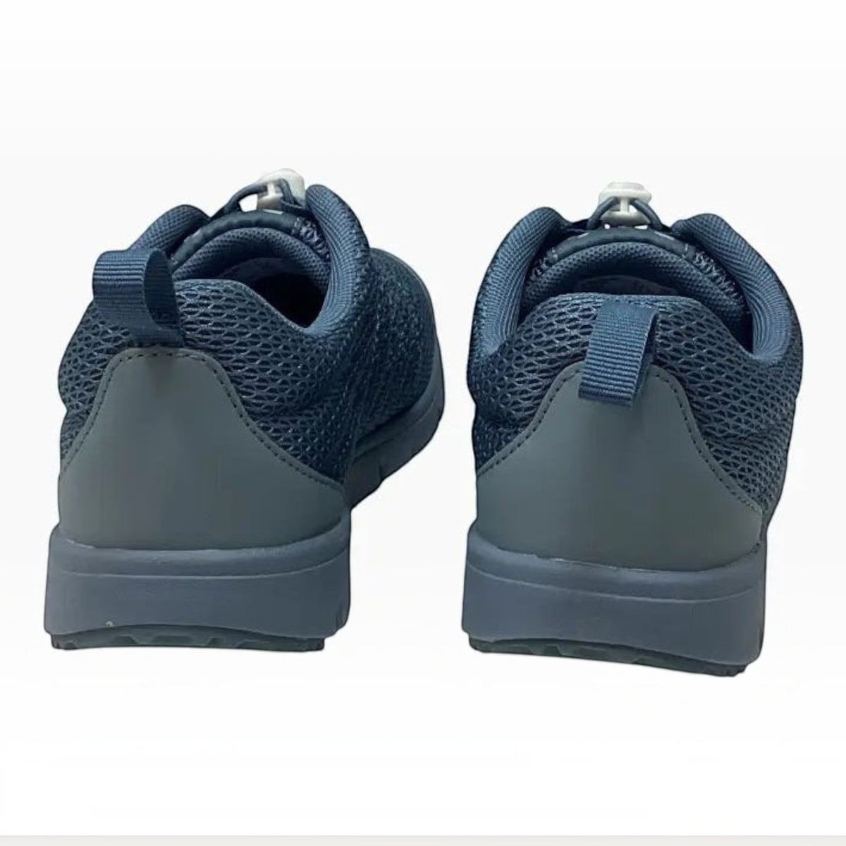 The Shoe Shop Propet Travel Walker II navy blue mesh walking shoes, rear view showing heel loops and rubber outsoles.