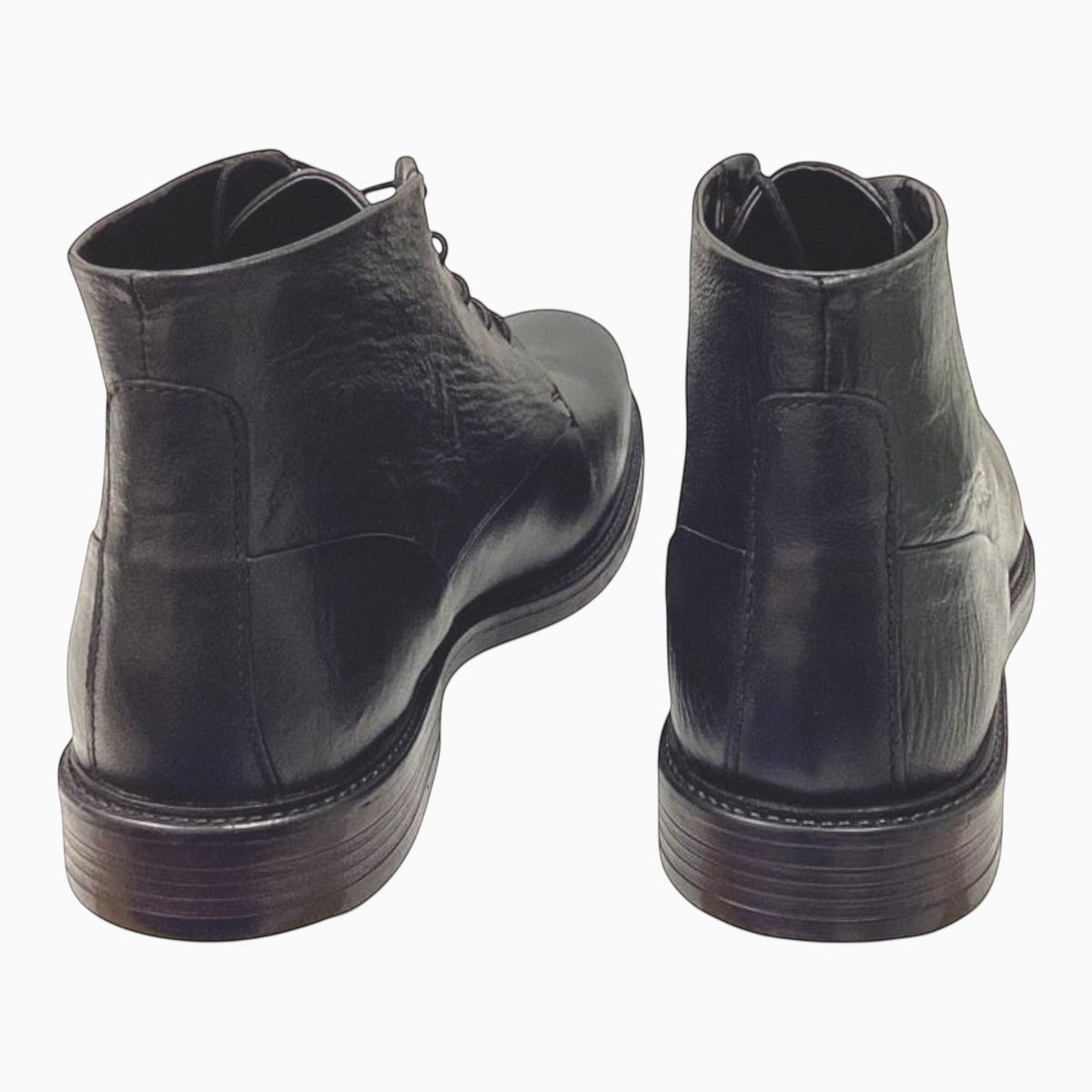The Shoe Shop Quota Boot in black leather, featuring a rear view of the ankle boot with a stacked heel.