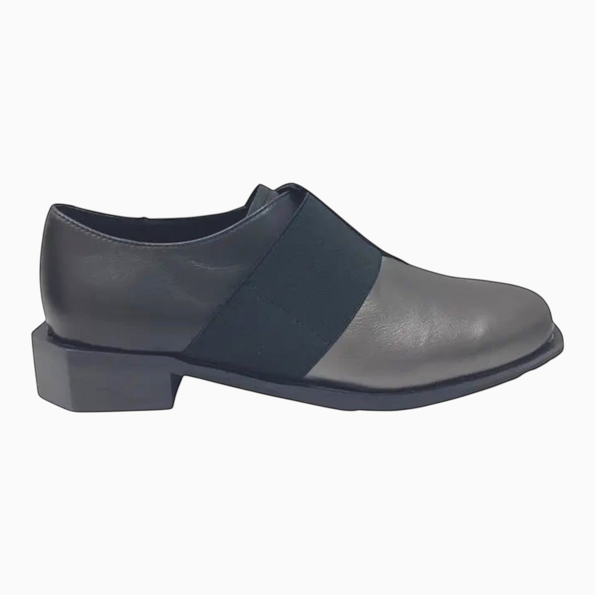 The Shoe Shop Raya flat shoe in pewter leather with a black elastic strap and low block heel, side view.