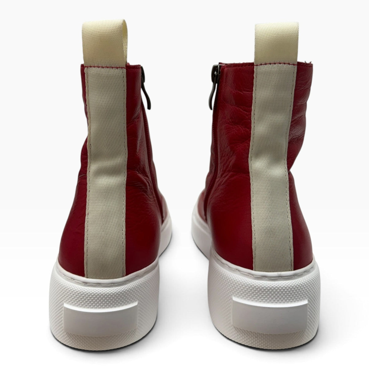 The Shoe Shop Robyn red leather ankle boots with white back pull tabs and thick white rubber soles, rear view.