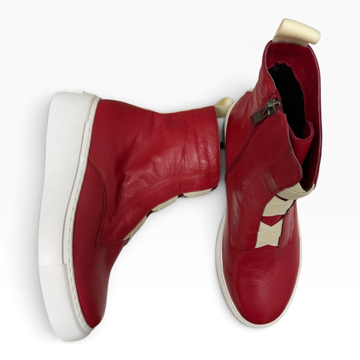The Shoe Shop Robyn red leather ankle boots with white soles and fluffy lining, shown from top and side angles.