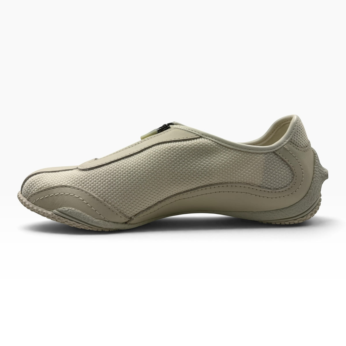 The Shoe Shop Relay Fly beige low-profile sneaker with a front zip, leather and mesh upper, and rubber outsole.