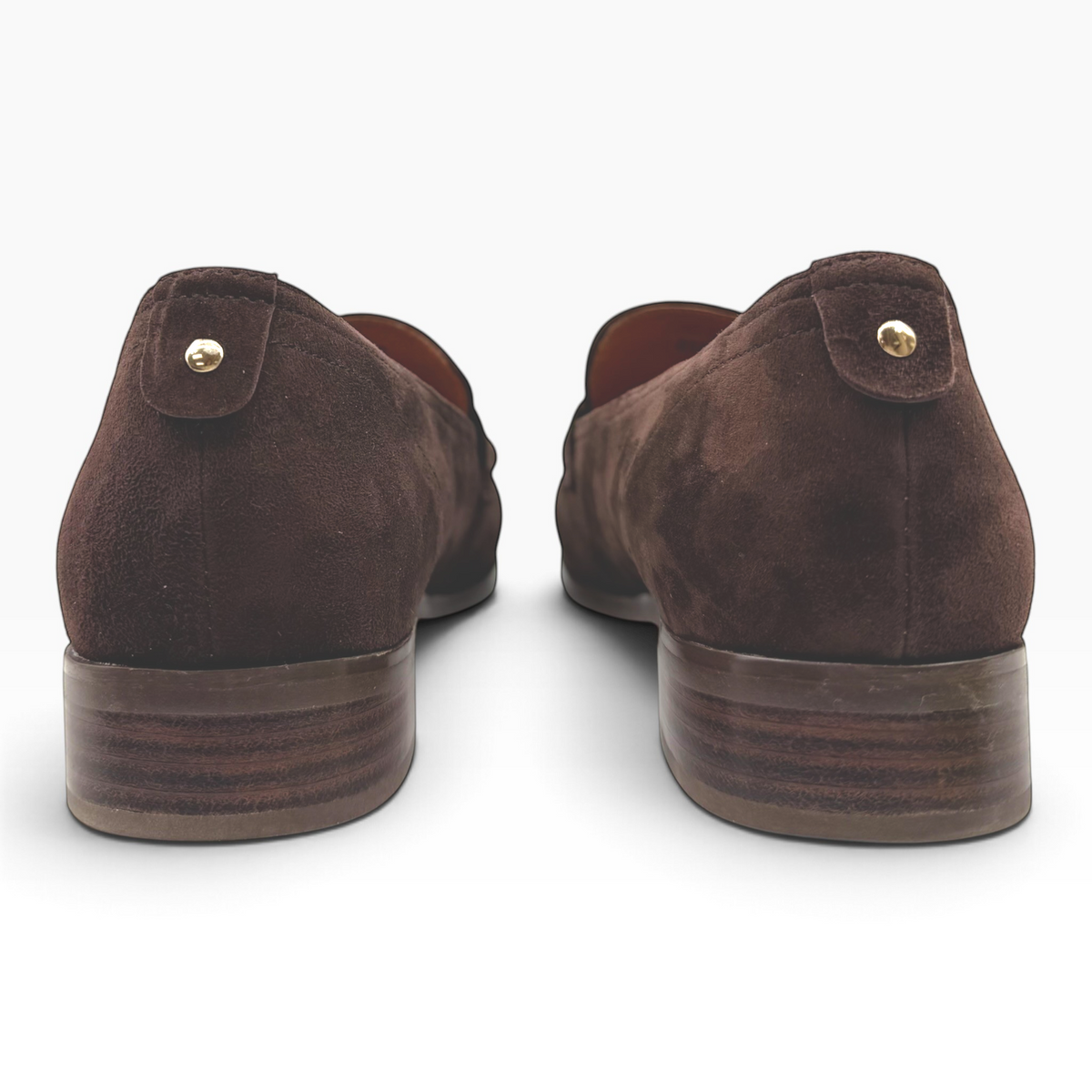 The Shoe Shop Rika dark brown suede loafers featuring a low stacked heel and gold-tone stud detail on the heel tab.