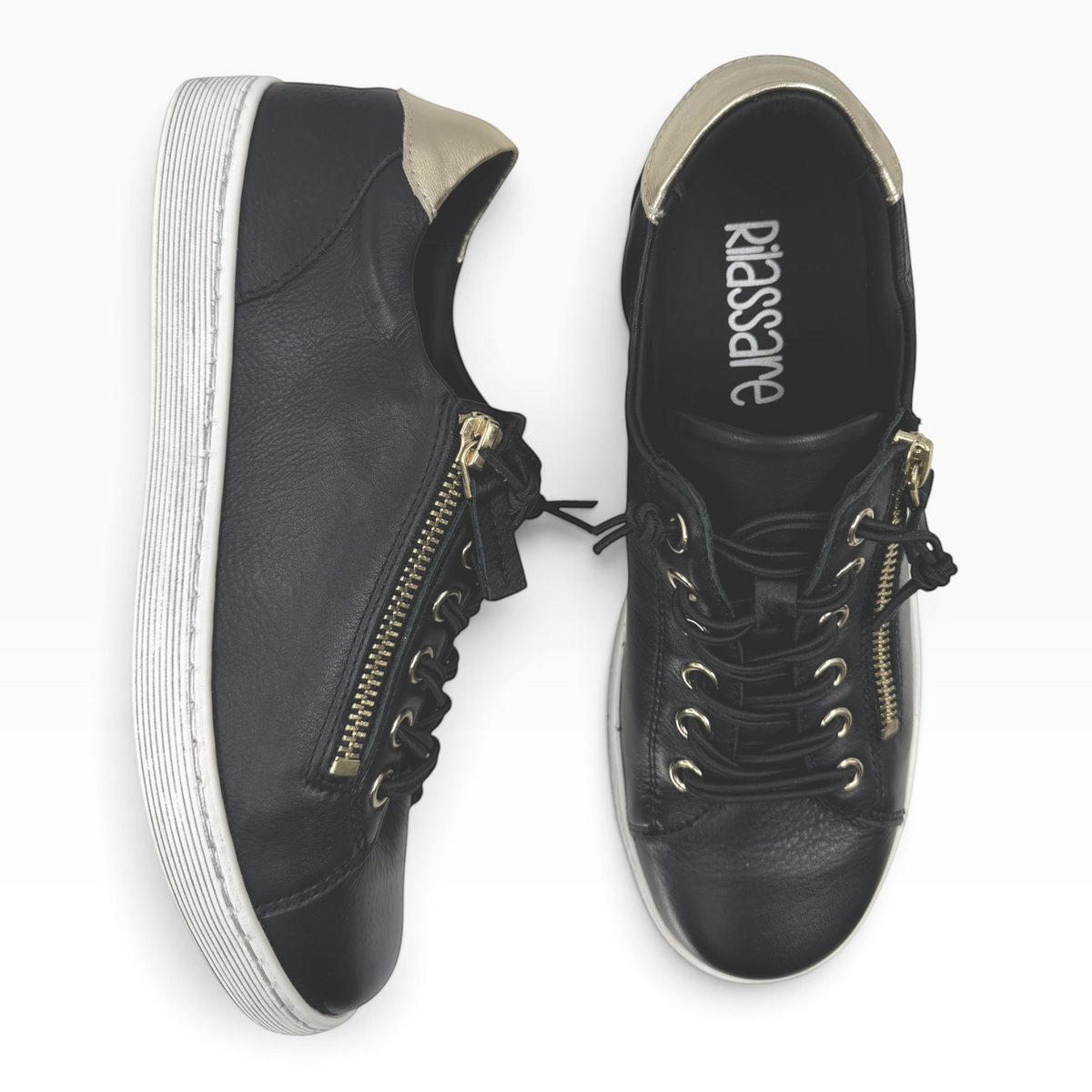 The Shoe Shop Rilassare Temi black leather sneakers with gold heel detail, side zip, and elastic laces.