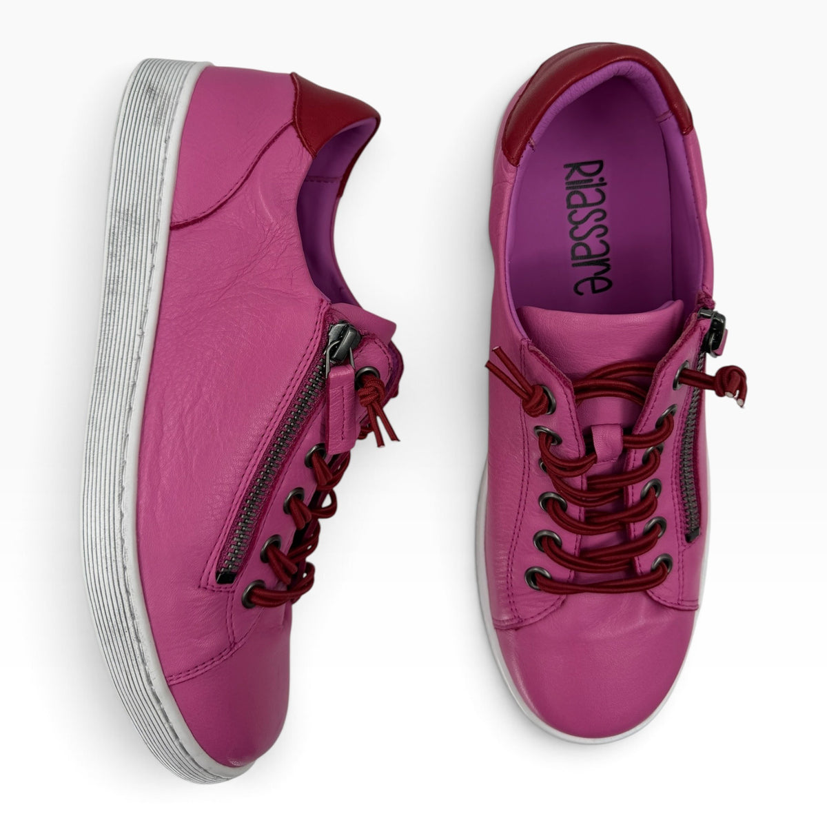 The Shoe Shop Rilassare Temi pink leather sneakers with side zip, elastic laces, and white durable soles.