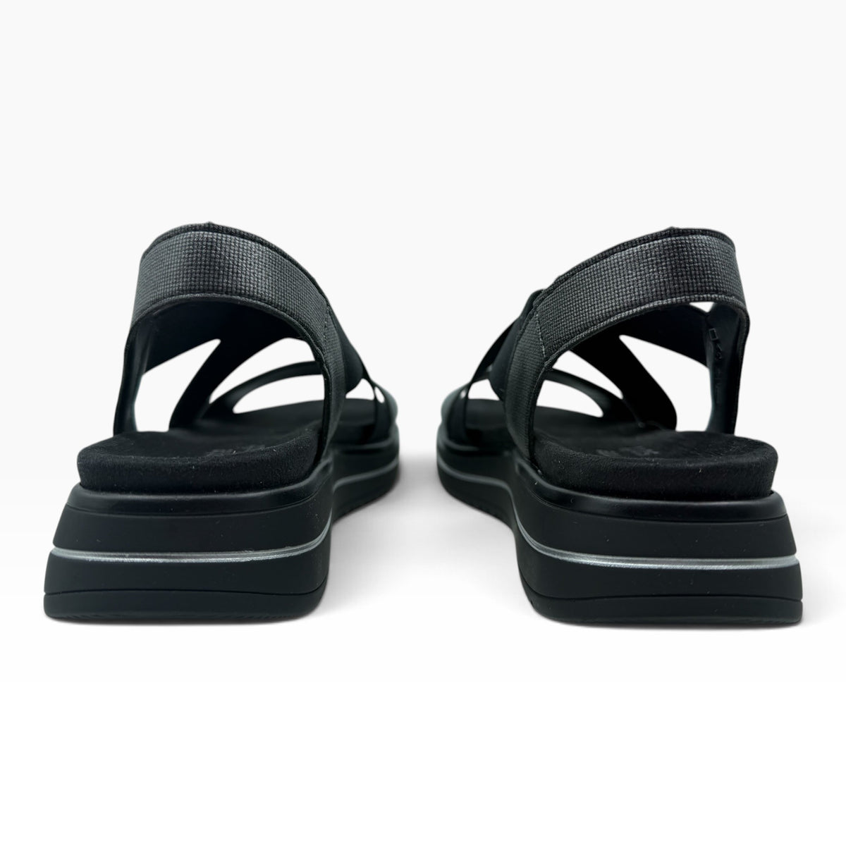 The Shoe Shop Sabrina black flatform sandals with elastic cross-straps and cushioned footbeds, rear view.