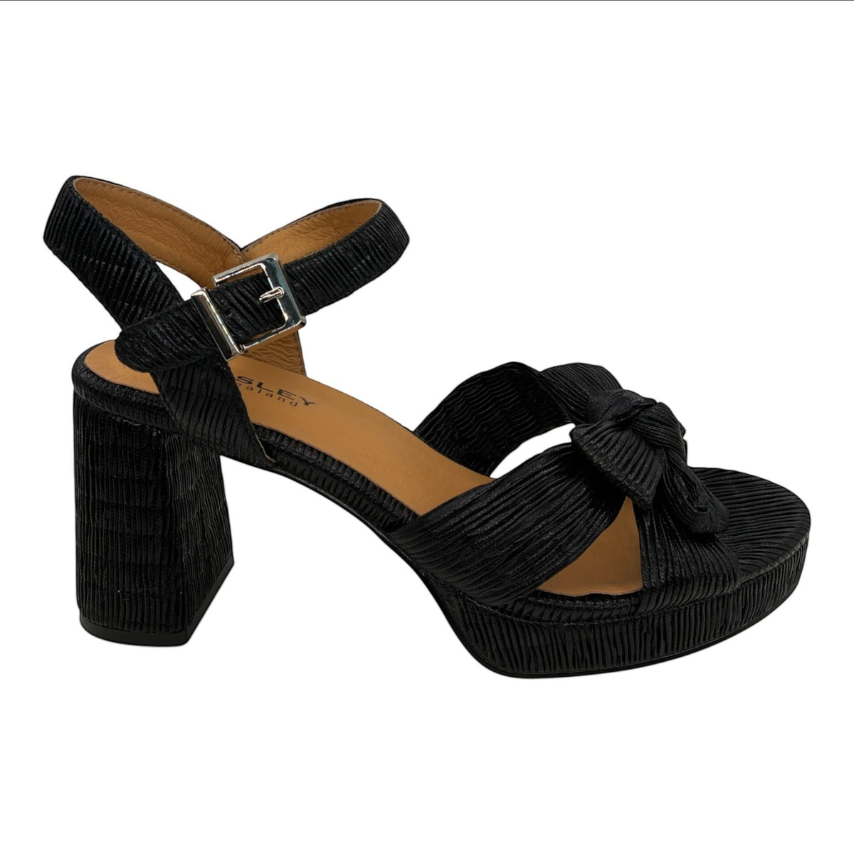 The Shoe Shop Sam black block heel sandal with a knotted bow, adjustable ankle strap, and textured finish.