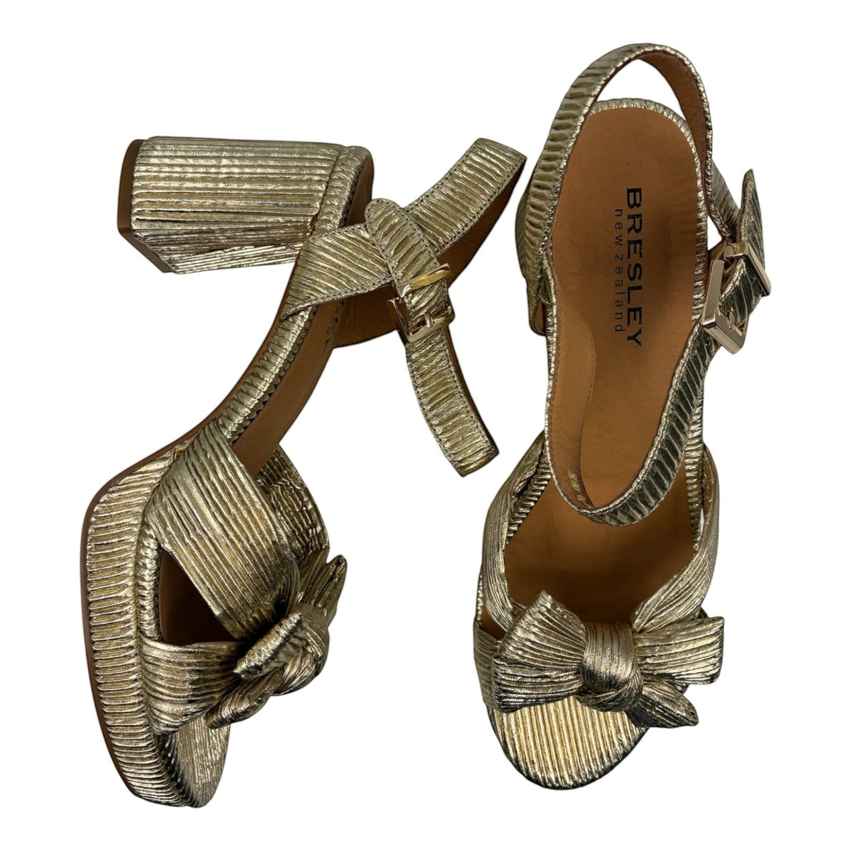 The Shoe Shop Sam gold metallic block heel sandals with a knotted bow detail and adjustable ankle strap