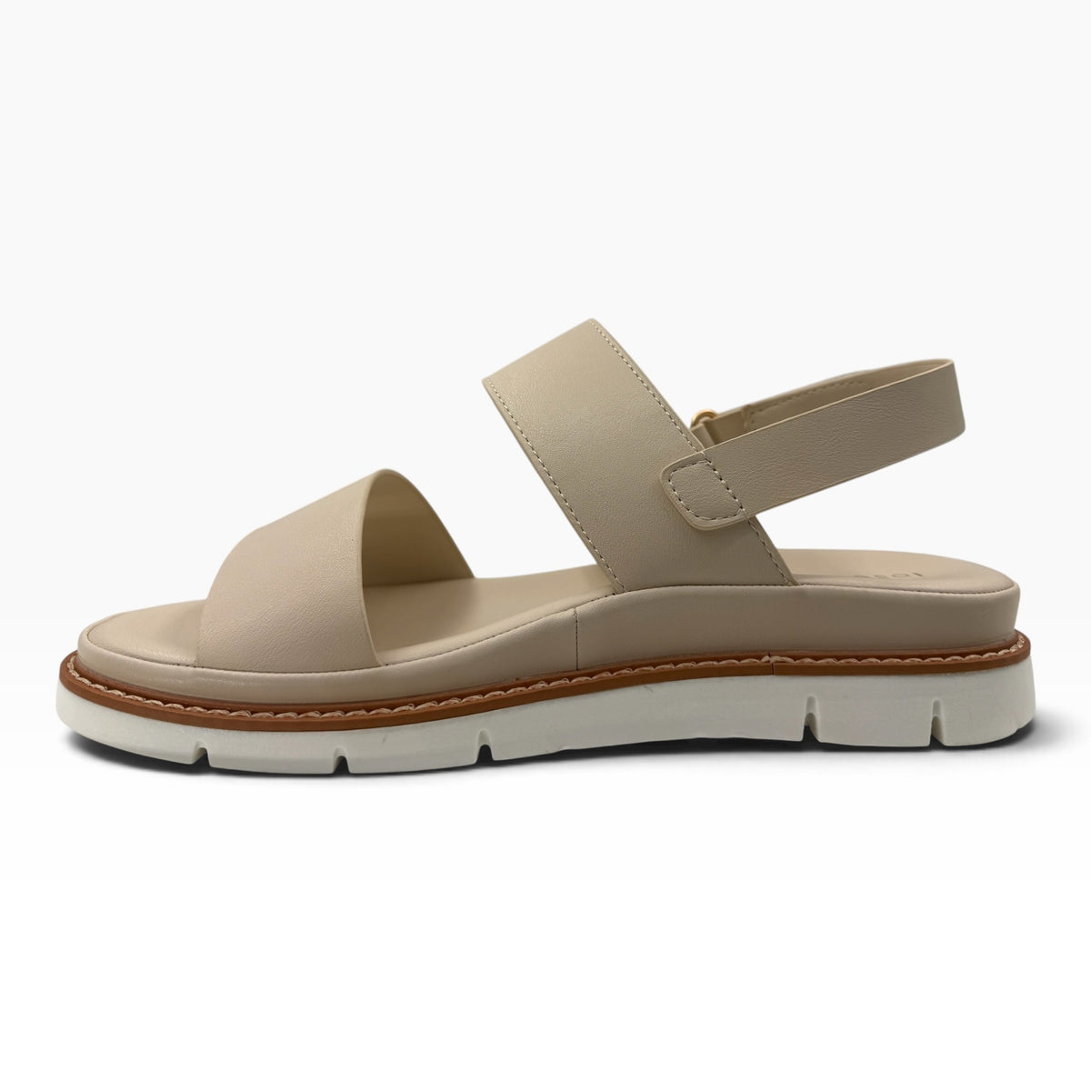 The Shoe Shop Sana beige leather wedge sandal with adjustable slingback strap, cushioned footbed, and lugged outsole.