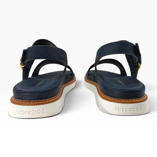 The Shoe Shop Sana leather wedge sandals in navy with a white platform sole, gold buckle, and slingback strap.