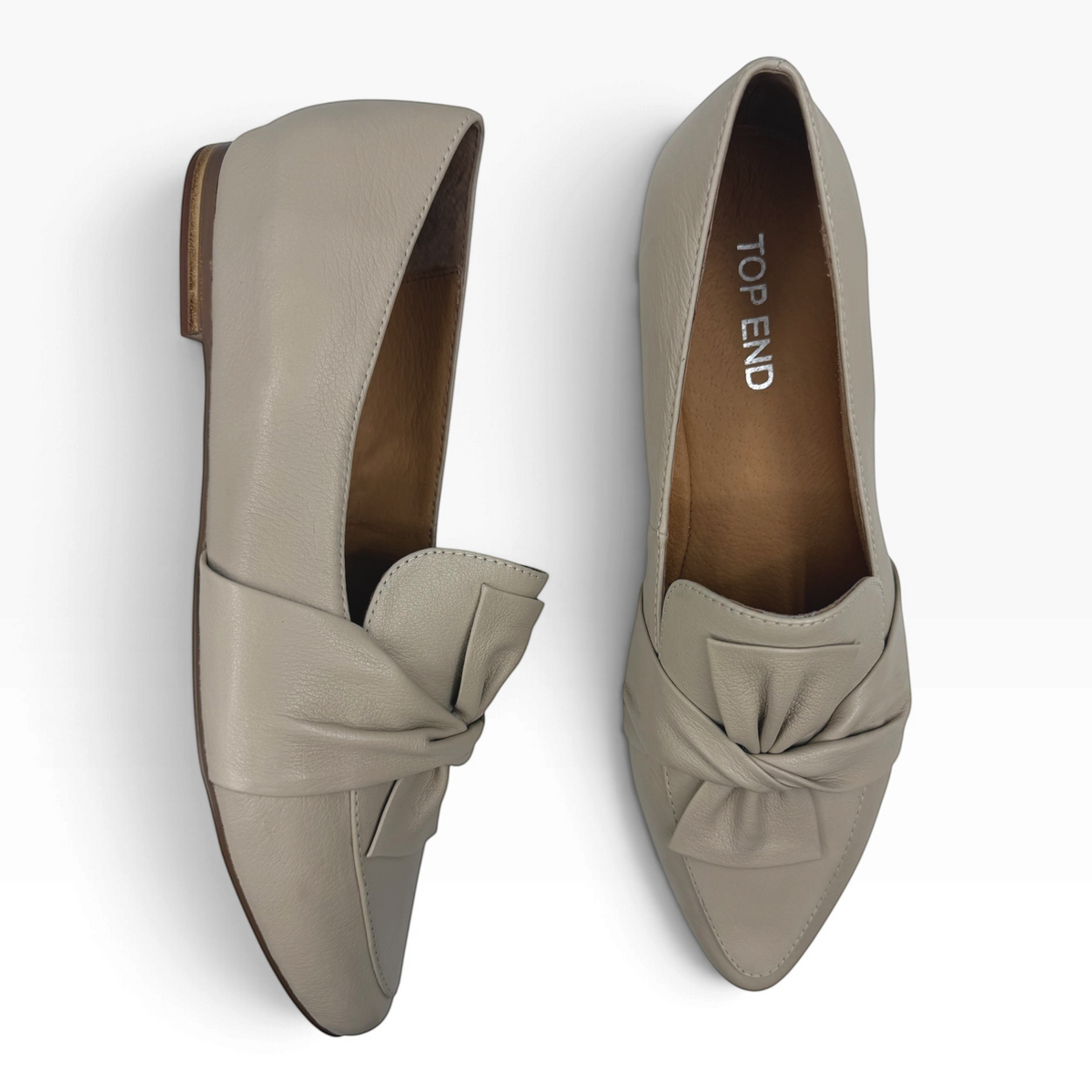 The Shoe Shop Sedone beige leather pointed-toe loafers featuring a decorative knotted bow detail on the vamp.