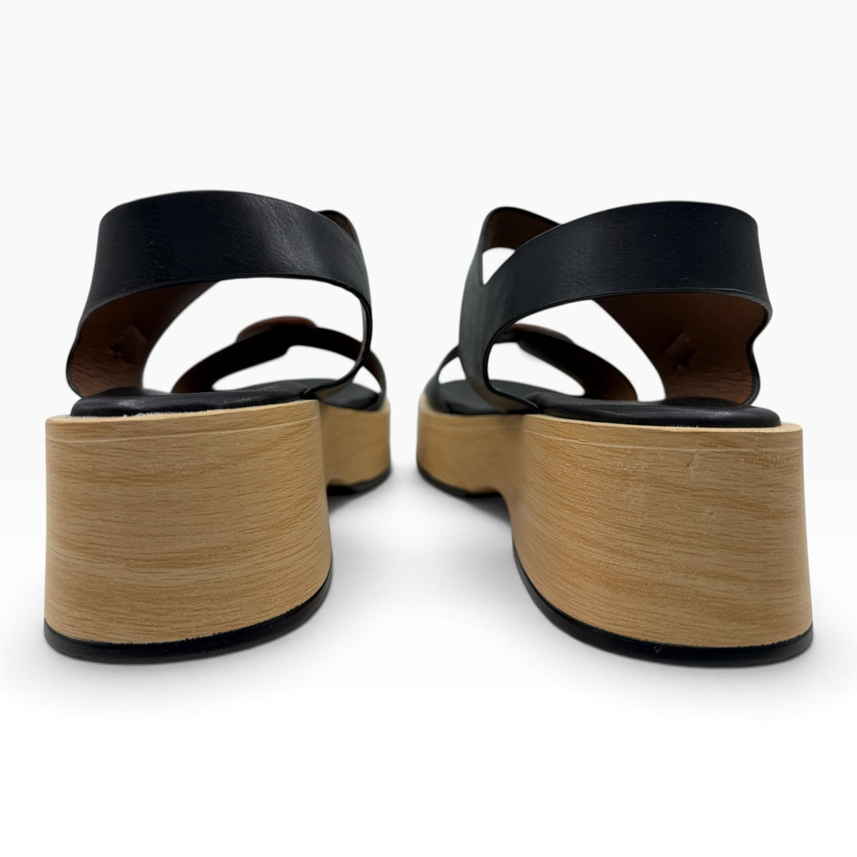 Back view of The Shoe Shop Selendra black leather platform sandals with light wood-effect soles