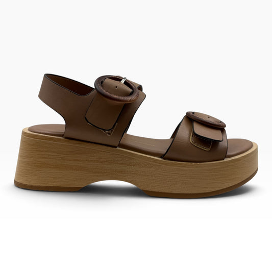 The Shoe Shop Selendra brown leather platform sandals with wooden-look soles and decorative buckle details.