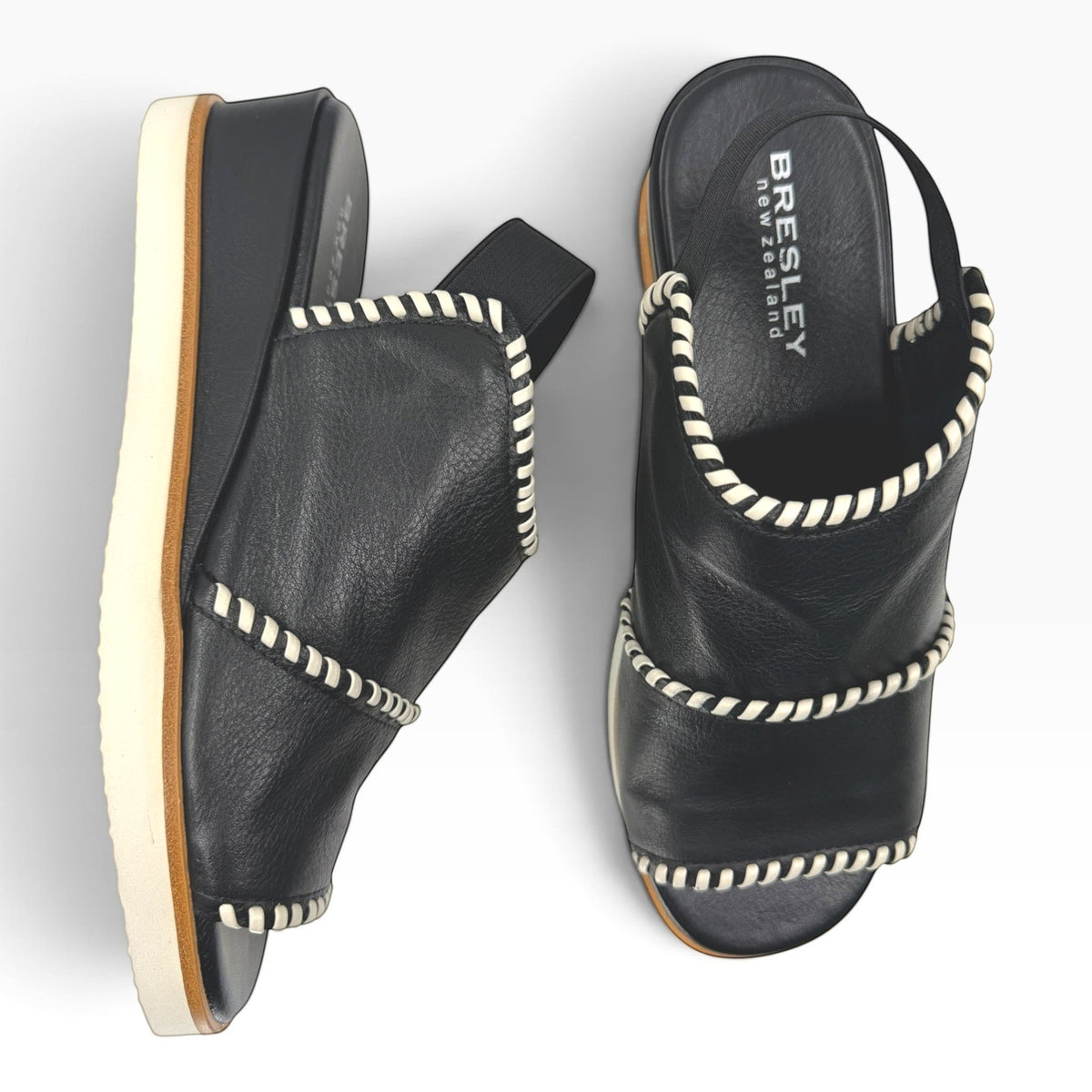 The Shoe Shop Sigma black leather wedge sandals with contrast white whipstitch detailing and elasticated slingback.