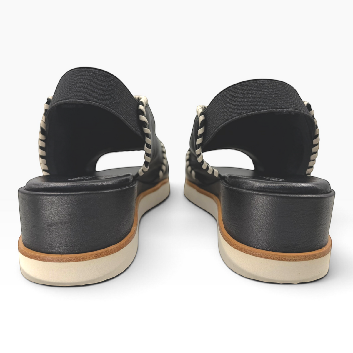 The Shoe Shop Sigma black leather wedge sandals featuring contrast whipstitching and an elasticated slingback strap.