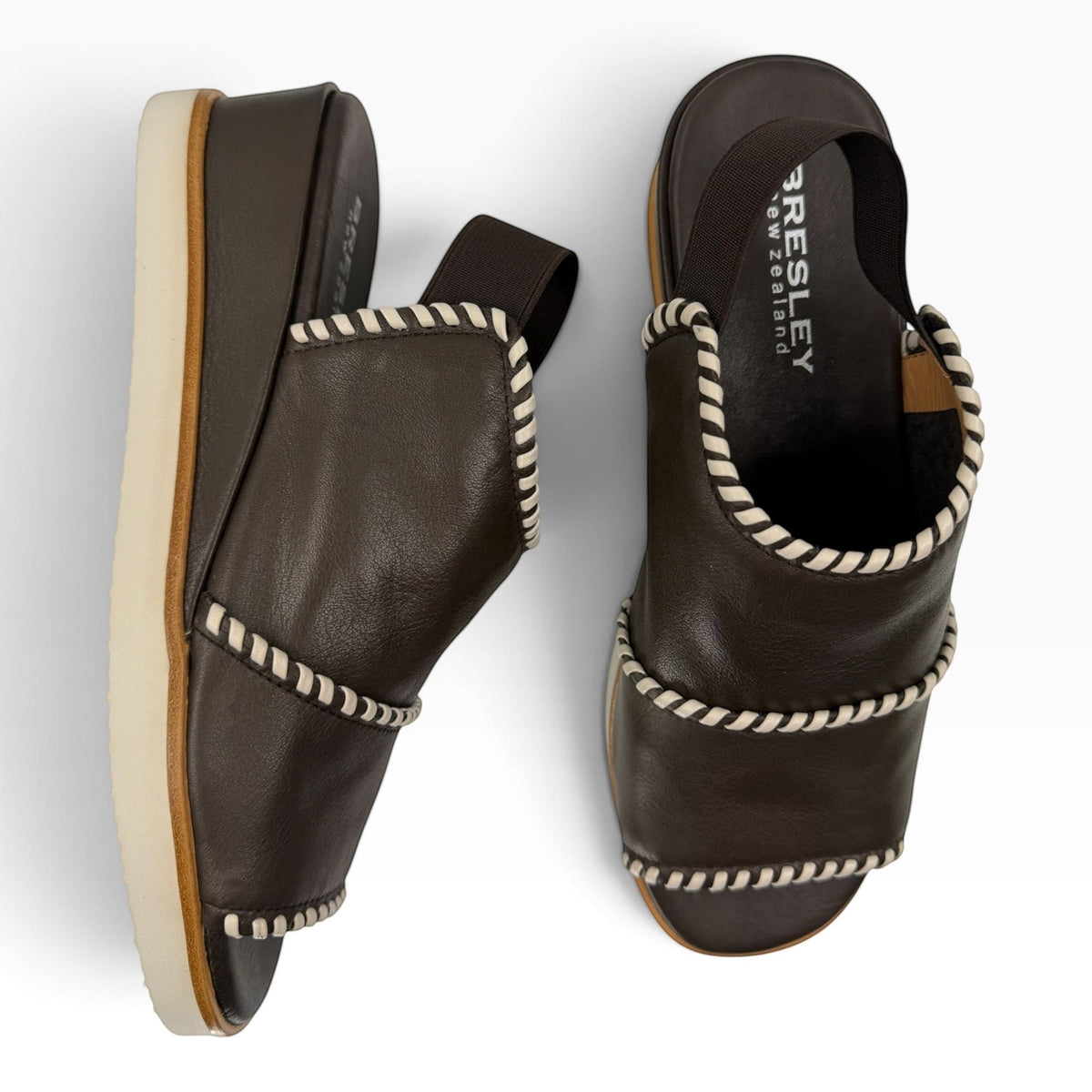 The Shoe Shop Sigma dark brown leather wedge sandals featuring contrast white whipstitch detailing and slingback strap.