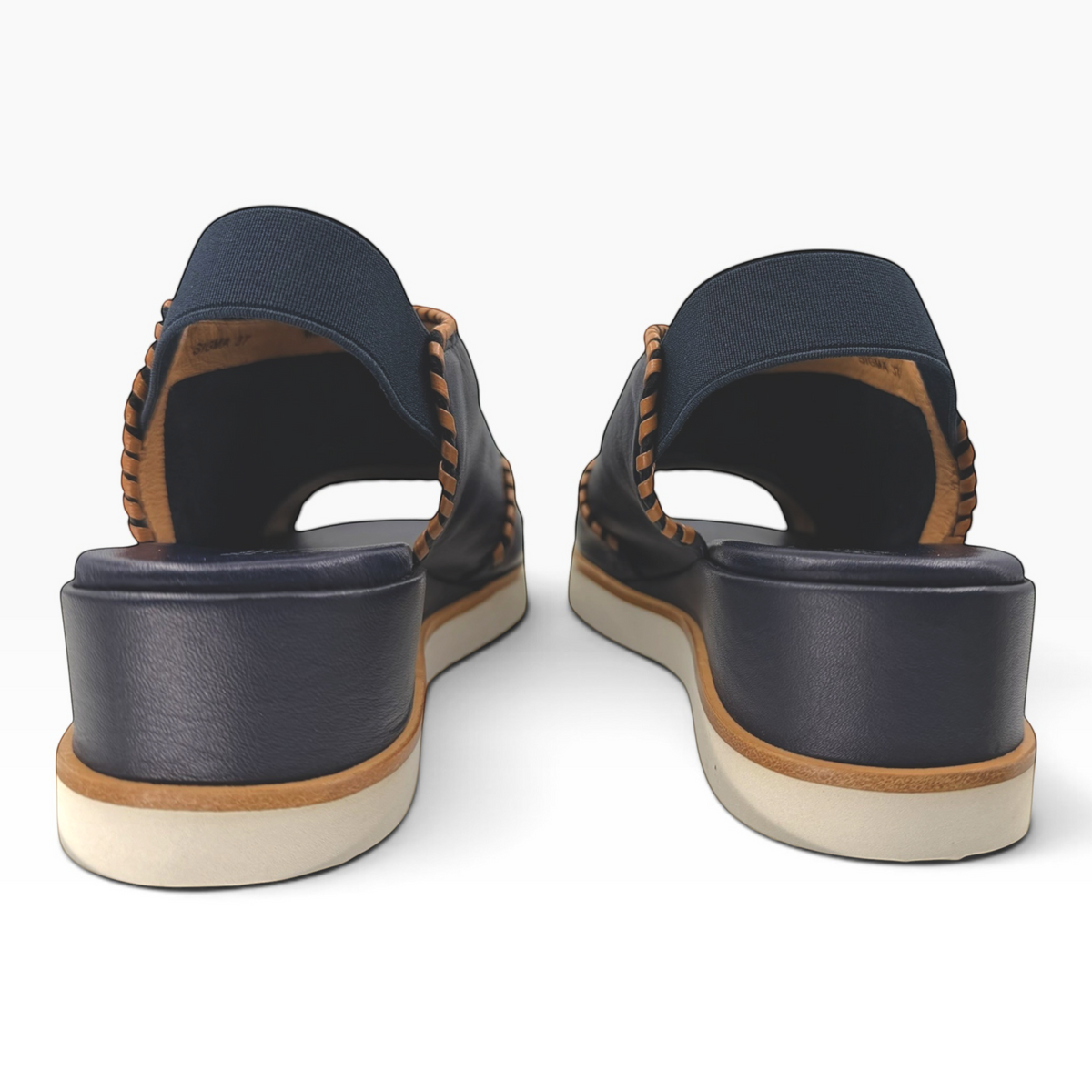 The Shoe Shop Sigma navy leather wedge sandals featuring contrast whipstitching and an elasticated slingback strap.