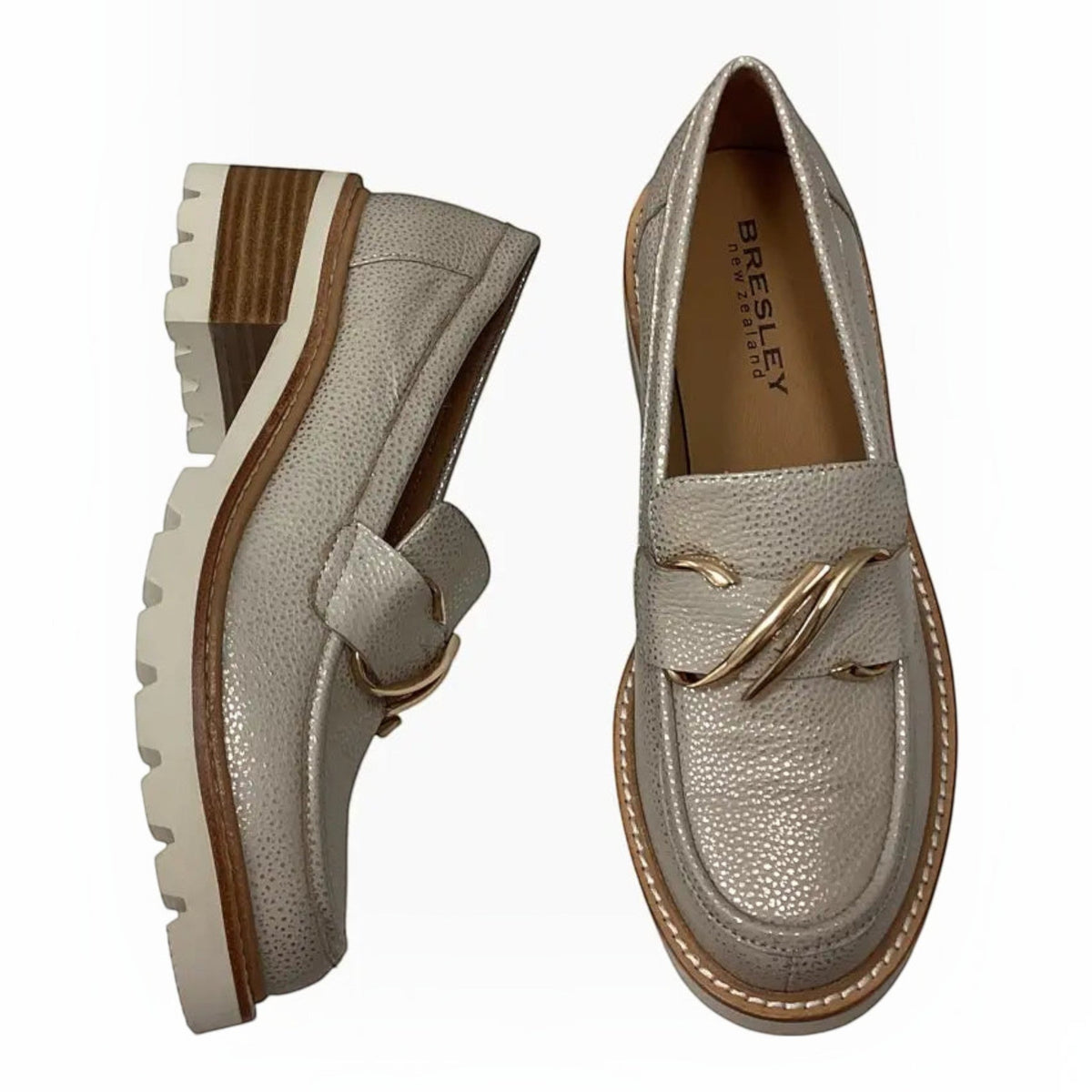 The Shoe Shop Bresley Dylan leather loafers in metallic silver with a gold-tone buckle, front zip, and block heel.