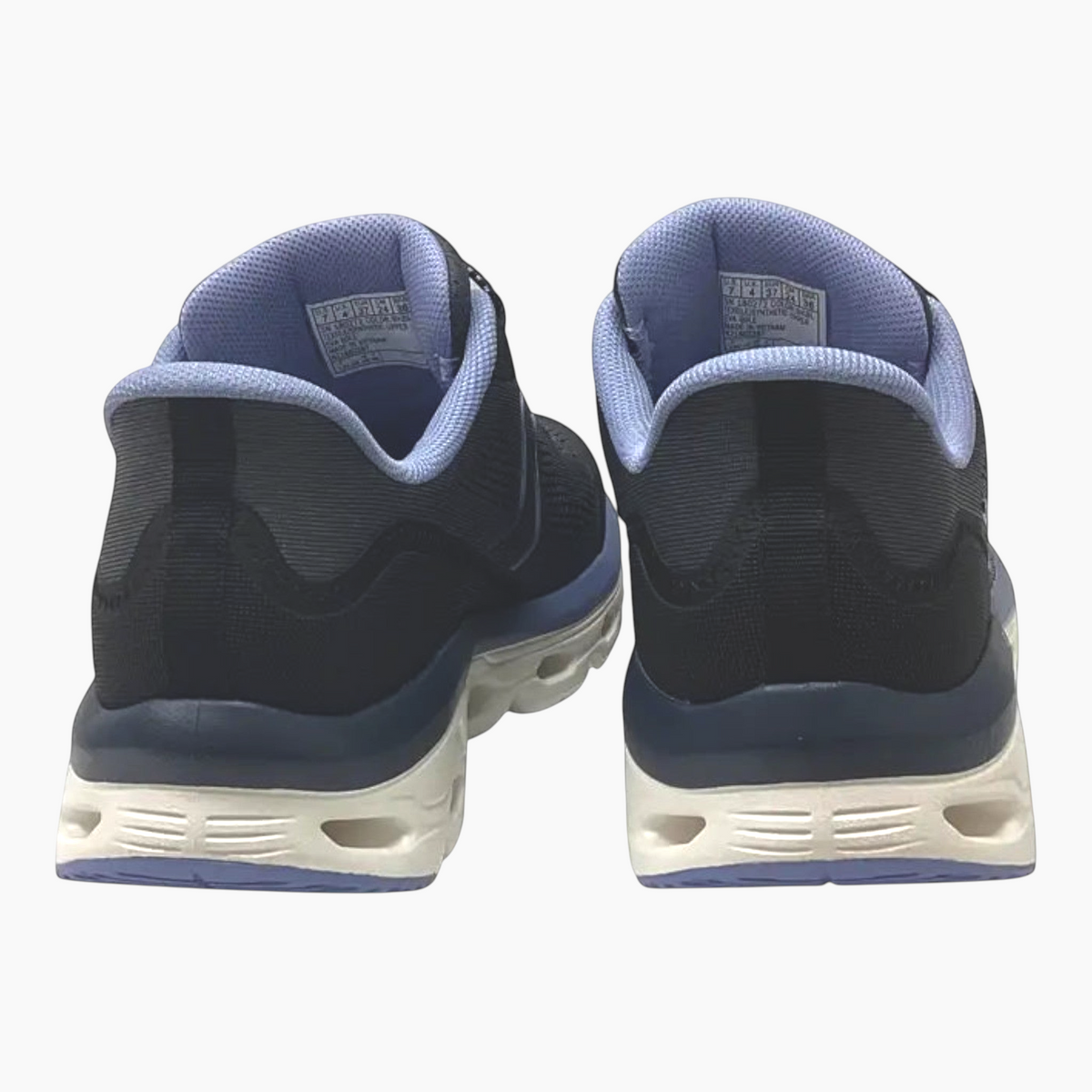 The Shoe Shop Skechers Glide-Step Sole sneakers in black and blue, showing the rear view of the cushioned midsoles.