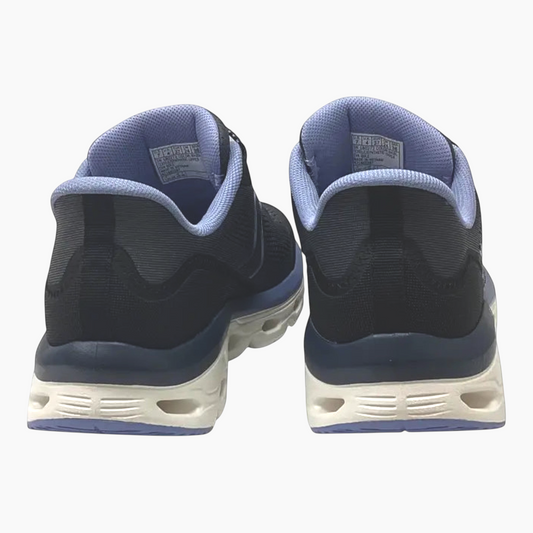 The Shoe Shop Skechers Glide-Step Sole sneakers in black and blue, showing the rear view of the cushioned midsoles.