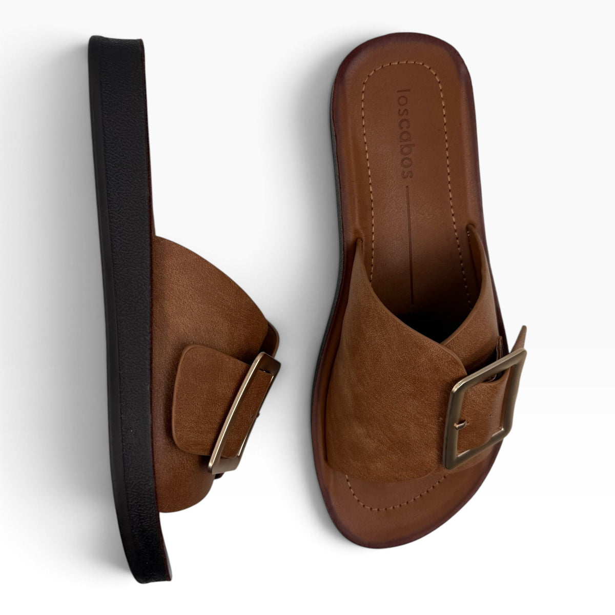 The Shoe Shop Skye Wide tan slide sandals with a wide strap, large gold-tone buckle, and a dark brown sole.