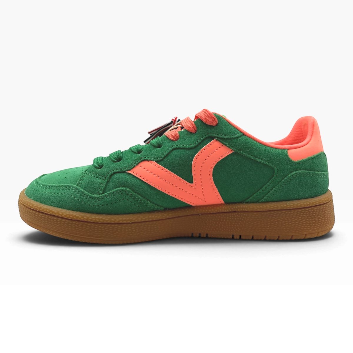 The Shoe Shop Smash Sneaker in green suede with coral accents, perforated toe, and a classic gum rubber sole.
