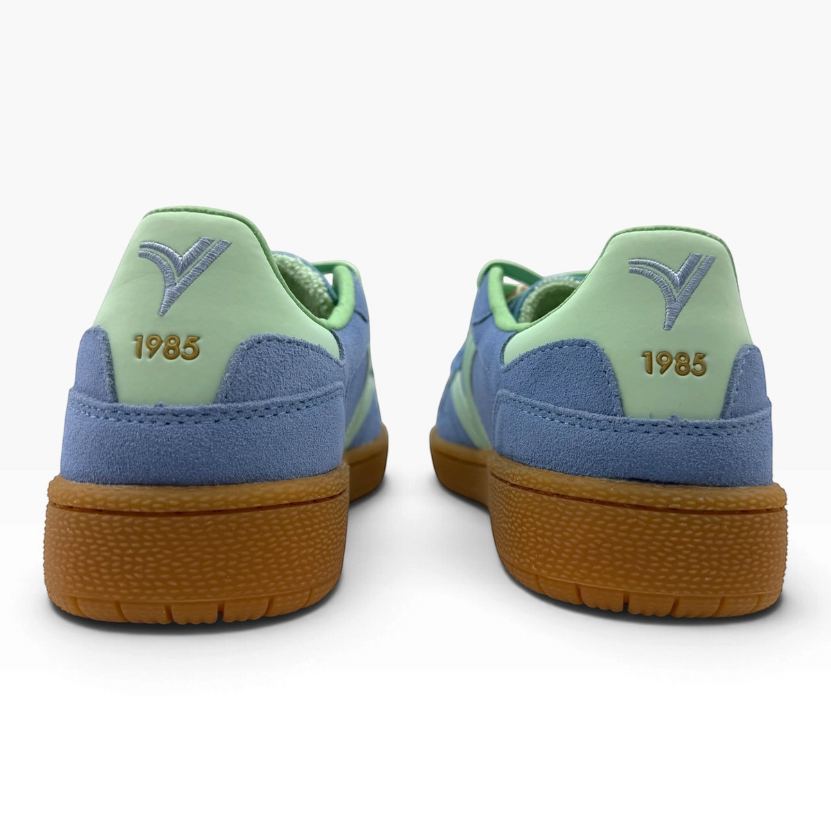 The Shoe Shop Smash Sneaker in blue suede with mint green accents, gum sole, and 1985 embroidery, rear view.
