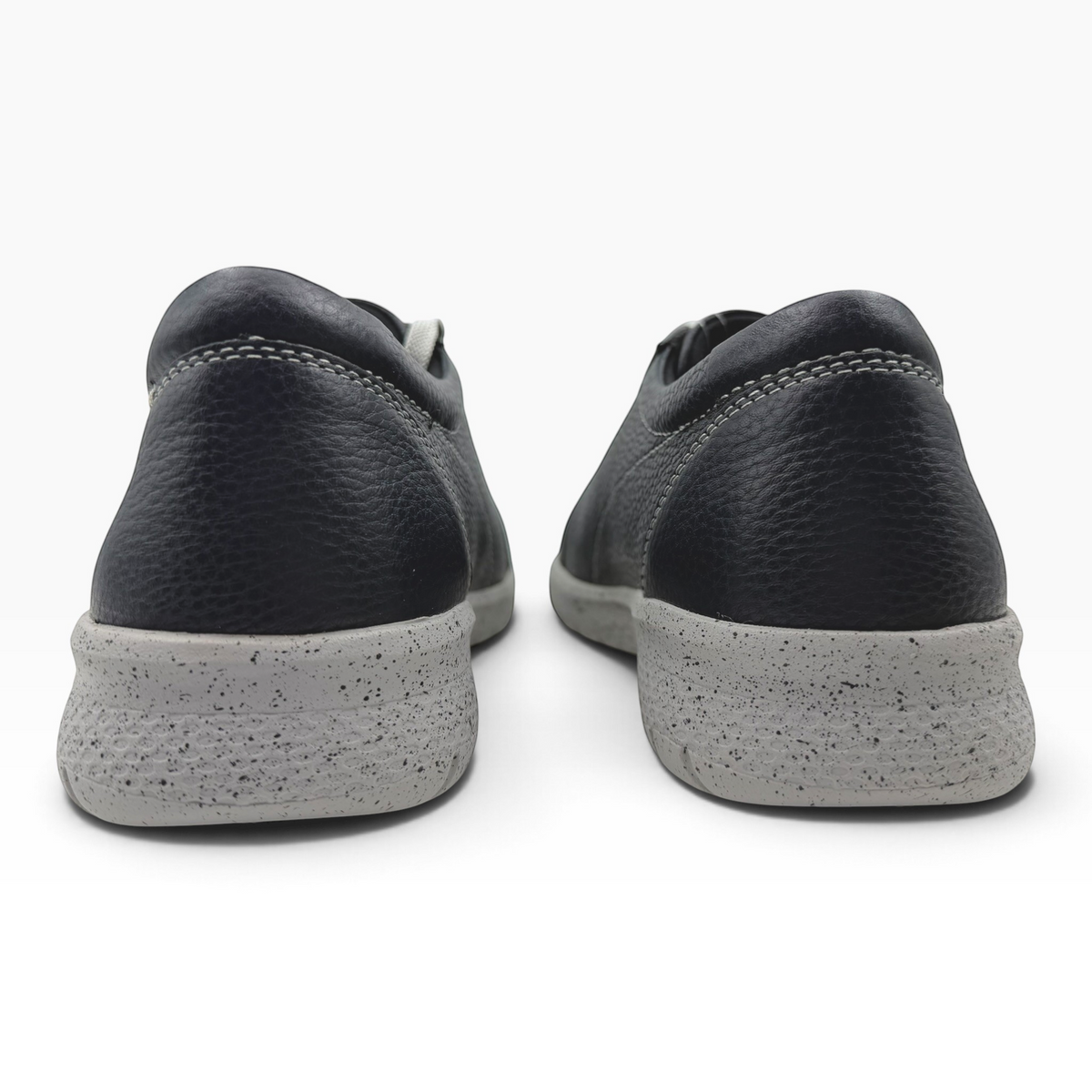 The Shoe Shop Solar XF leather sneakers in black with a grey speckled slip-resistant sole, rear view.