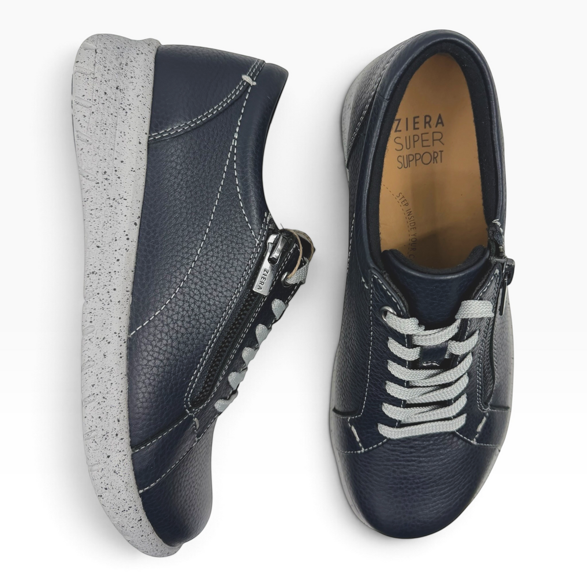 The Shoe Shop Solar XF navy leather sneakers with side zip, lace-up front, and speckled grey supportive sole.