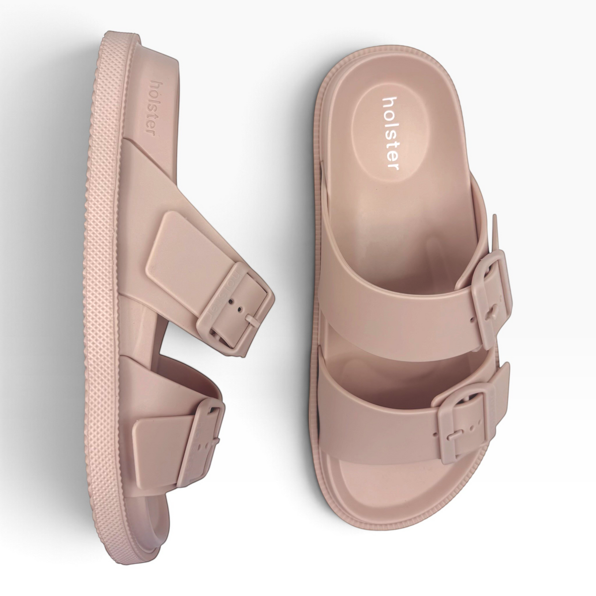 The Shoe Shop Soleseeker beige slide sandals with adjustable buckle straps and a cushioned footbed.