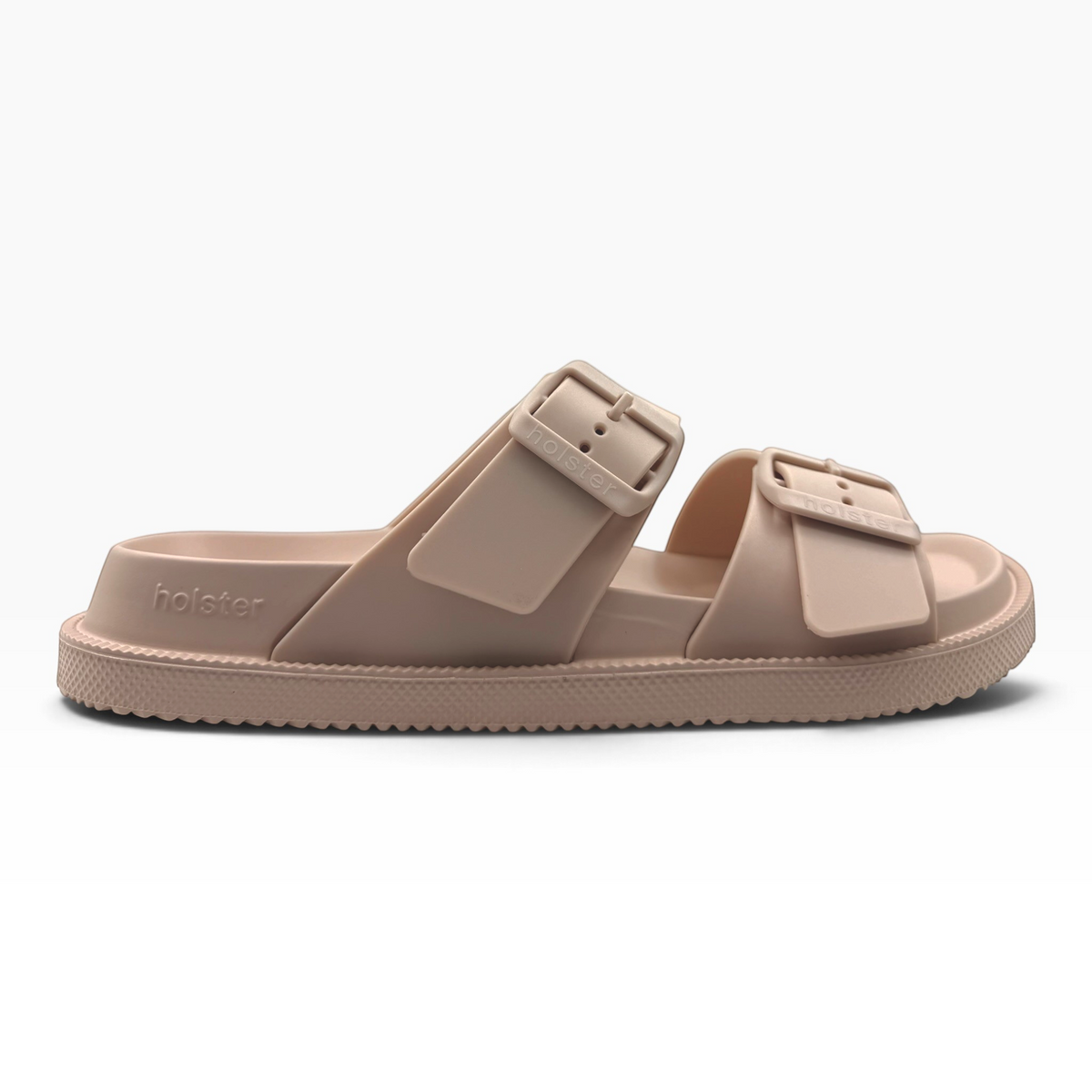 The Shoe Shop Soleseeker slide in beige with adjustable double straps, cushioned footbed, and textured rubber sole.
