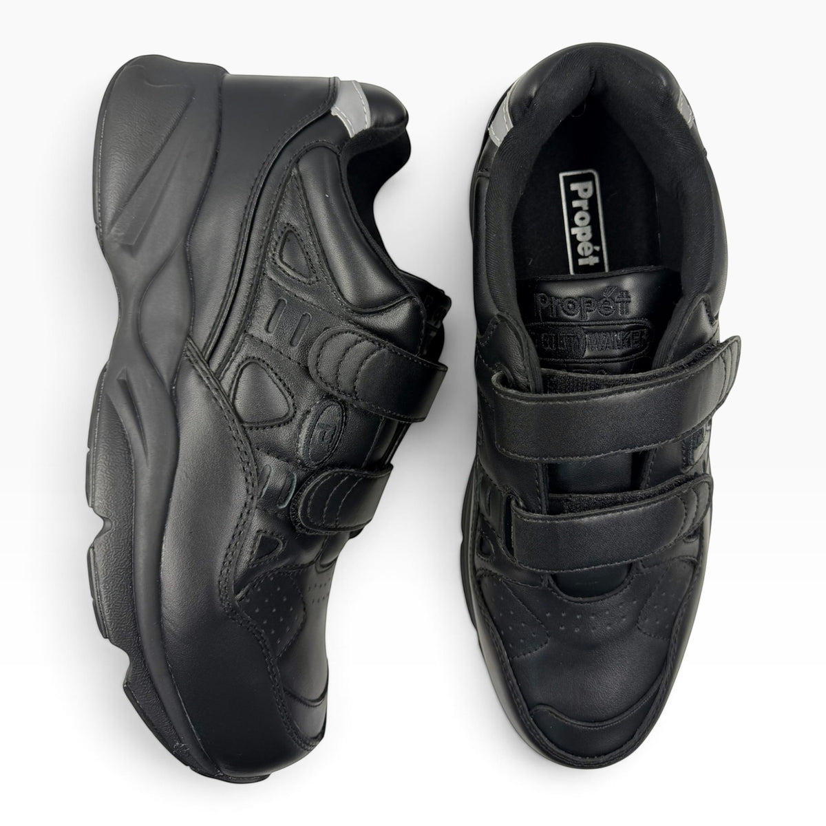 The Shoe Shop Stability X Strap 5E black orthopedic walking shoes with dual hook-and-loop closures and thick soles.