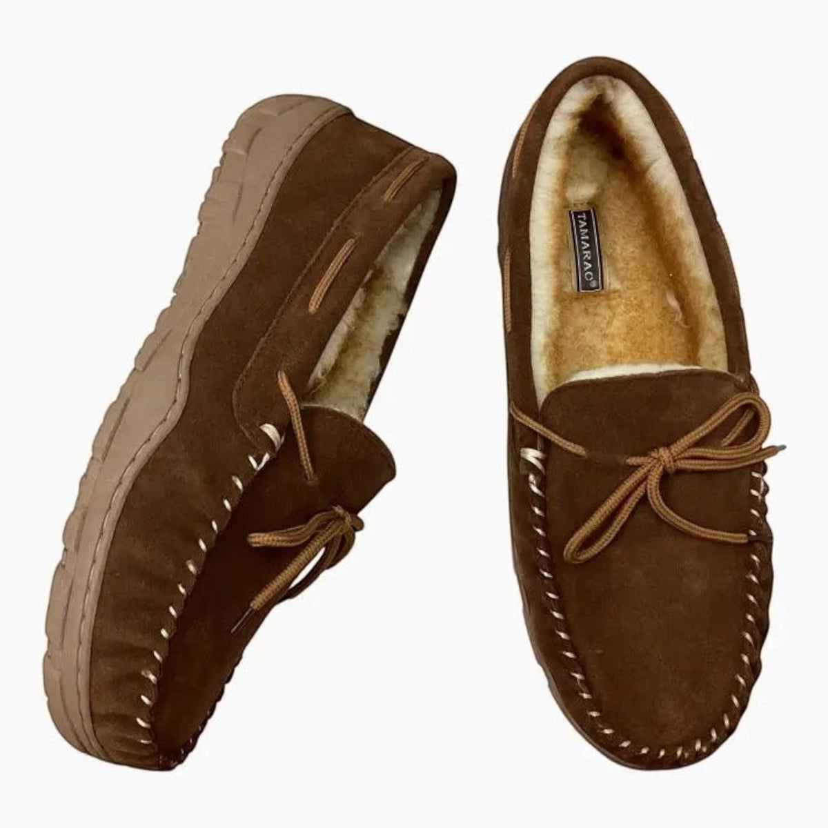 The Shoe Shop Tamarac Utah brown suede moccasin slippers with plush fleece lining and decorative lace-up detail.