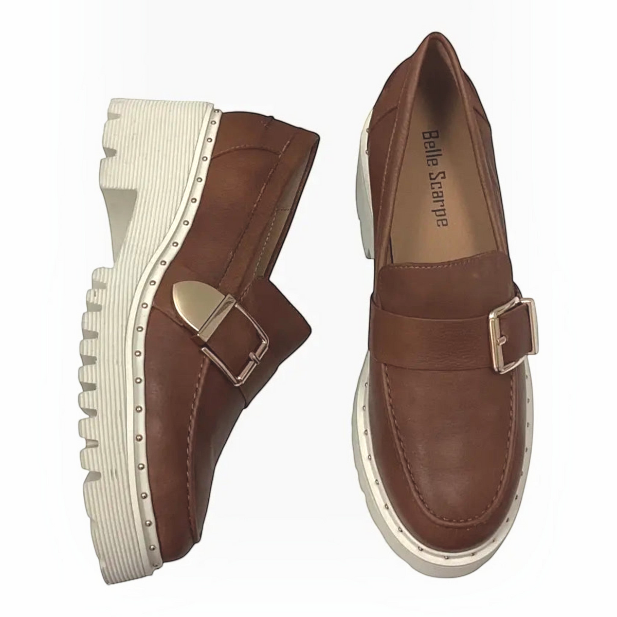 The Shoe Shop Belle Scarpe tan leather loafers with gold buckle, stud trim, and a chunky off-white lug platform sole.