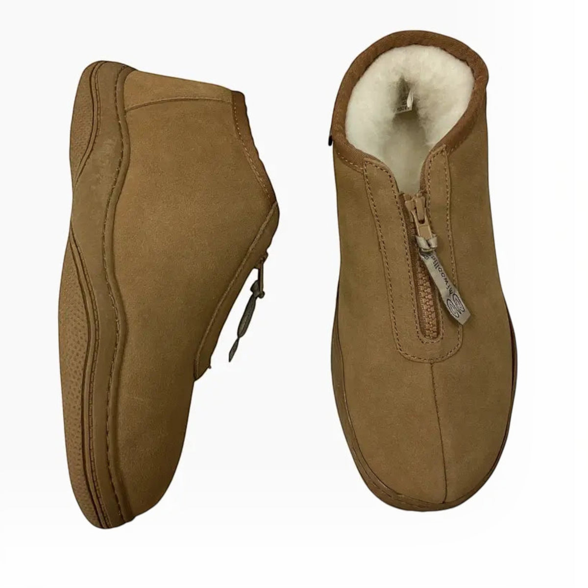 The Shoe Shop Dobson slippers in tan leather with plush white wool lining, front zip closure, and durable TPR soles.